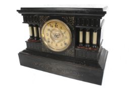 A vintage Ansonia USA black painted metal cased clock. Striking to a gong.