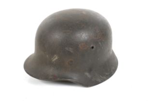 A WWII German M40 pattern helmet. SS Sturm Fritz Grasse painted inside, marked size 56 on liner.