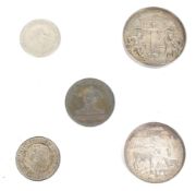 A collection of three medallions and a few coins.