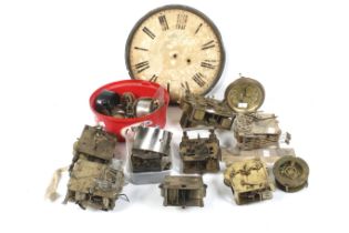 A collection of assorted vintage clock parts and spare mechanisms.