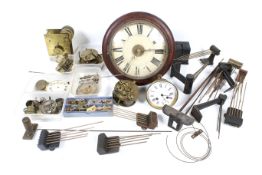 A collection of assorted vintage clock spare parts. In a wooden bin.