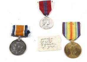 A collection of three WWI medals.