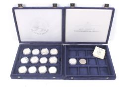 A collection of thirteen assorted silver proof commemorative crown coins.