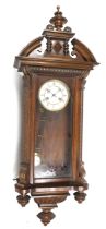 A Vienna style striking wall clock by Jungens. No. 3836. With a carved and turned wooden case.