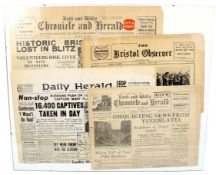 The framed front pages of four WWII British newspapers.