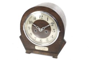An Art Deco oak cased chiming mantel clock. A German movement.