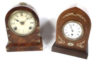 Two vintage arched top wood cased mantel clocks.
