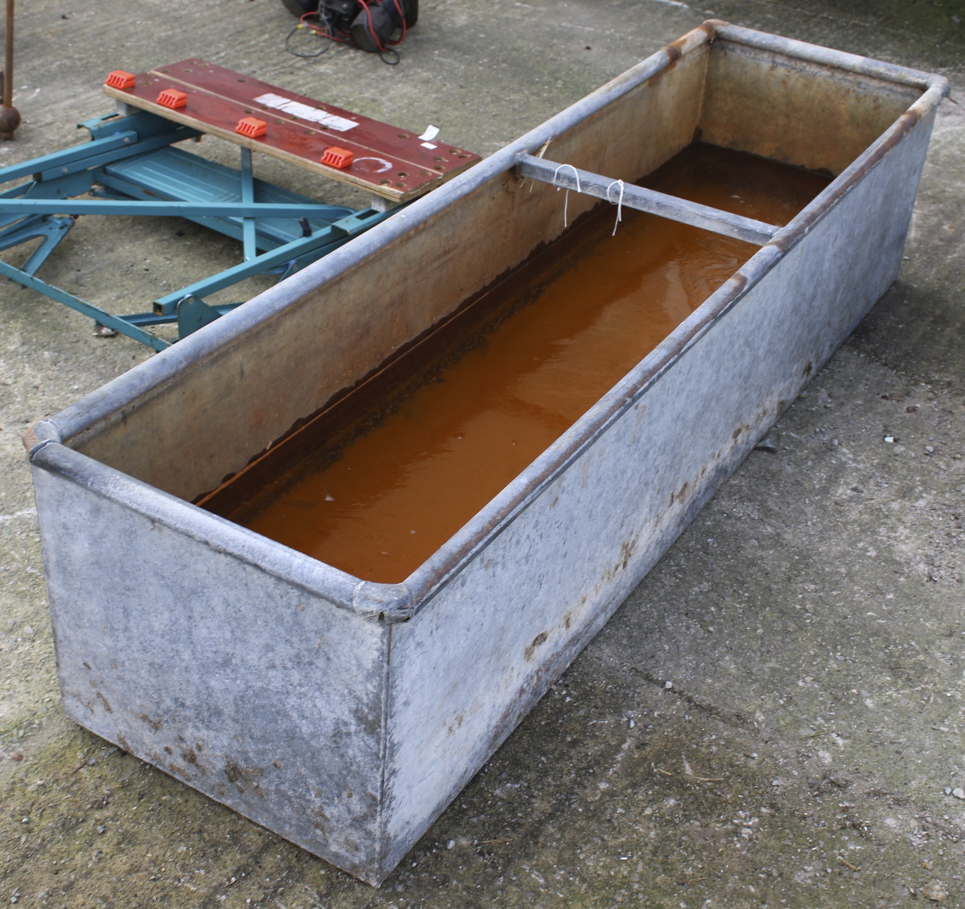 A long galvanised animal water trough.