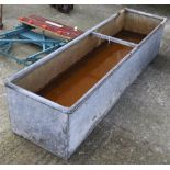 A long galvanised animal water trough.