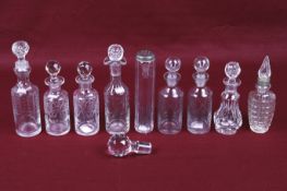 A collection of nine assorted vintage glass bottles with some stoppers. Max.