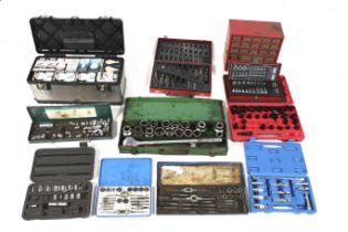 A group of assorted tool boxes and spanner sets.