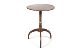 A wooden circular topped tripod lamp table.