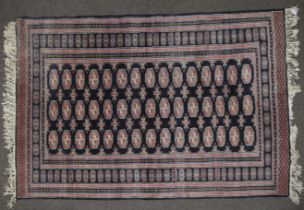 A Persian style woollen rug.