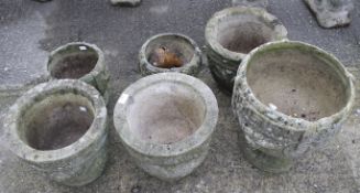 Six composite stone garden pots.