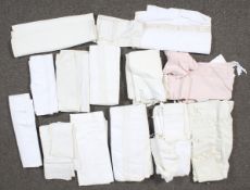 An assortment of textiles. Constructed of linen and cotton, featuring tablecloths, napkins, etc.