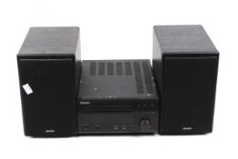 A Denon CD player receiver RCD-M38DAB and a pair of shelf speakers.