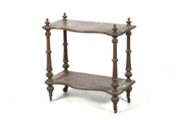 A Victorian wooden two tier stand. With later added casters.