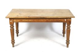 A 20th century pine kitchen table.
