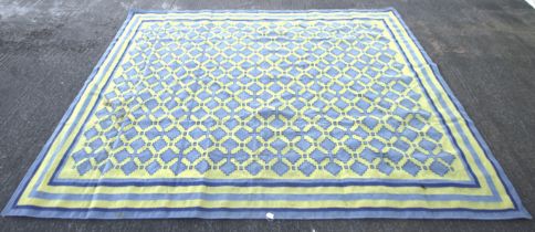 A large contemporary blue and yellow wool rug.