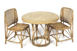 A wicker and bamboo circular table with two chairs.
