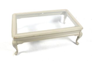 A contemporary grey painted glass top coffee table.