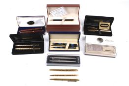 A collection of assorted fountain and ball point pen sets.