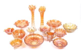 A large collection of orange carnival glass. Including a pair of vases, pedestal bowls, a jug, etc.