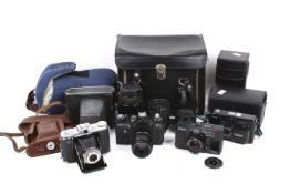 An assortment of film cameras, lens and accessories.