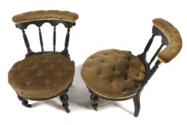 A pair of button back upholstered Victorian ebonised nursing chairs.