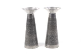 A pair of mid-century white metal candlesticks.
