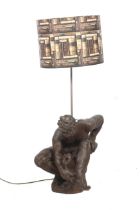 A cast metal lamp base. Modelled as a classical figure of a man holding an urn.