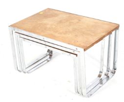 A mid-century nest of three tables. All with wooden tops mounted on a one piece chrome metal frame.
