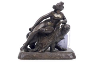 A Regency style metal sculpture of a nude woman seated on a lioness, on a plinth base.