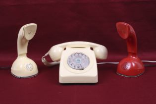 Three mid-century rotary telephones.