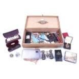 An assortment of collectables contained within a cigar box.