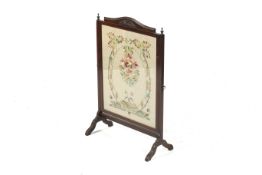 A Victorian style fire screen.