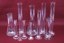 A collection of assorted vintage scientific laboratory glass items.