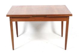 A mid-century drawer leaf extending dining table.