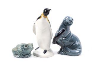 Three mid-century Poole Pottery animal figures. Including a frog, an otter and a penguin. Max.