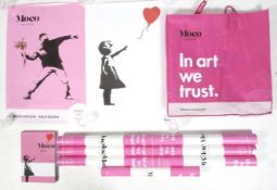 Seven Banksy Moco Museum posters and a book.