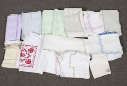 A large assortment of textiles. Including tablecloths, napkins, etc.