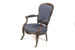 A Victorian mahogany framed spoonback elbow chair.
