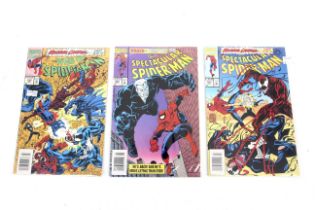Three Spiderman comic books.