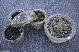 Four composite stone garden pots and a decorative fossil. All the pots with moulded details, Max.