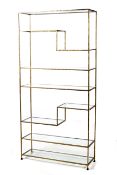 A continental gilt metal freestanding shelf. Hammered metal finish and glass shelves.