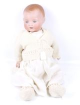 A vintage 'A M' Armand Marseille bisque head baby doll.