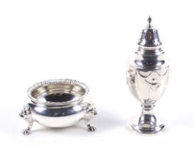 An Edwardian silver vase shaped pepper pot and a later cauldron shaped salt cellar.