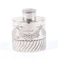 An Edwardian silver oval part-fluted tea caddy.