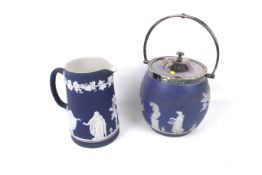 Two pieces of Jasperware. Comprising an Adams Tunstall jug and a Wedgwood biscuit barrel, Max. H23.