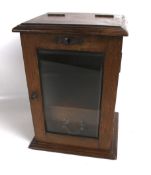 An early 20th century oak smokers cabinet.